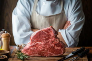 Non-Toxic Rodent Control That Protects People, Product and Wildlife - this image shows a butcher with a joint of beef