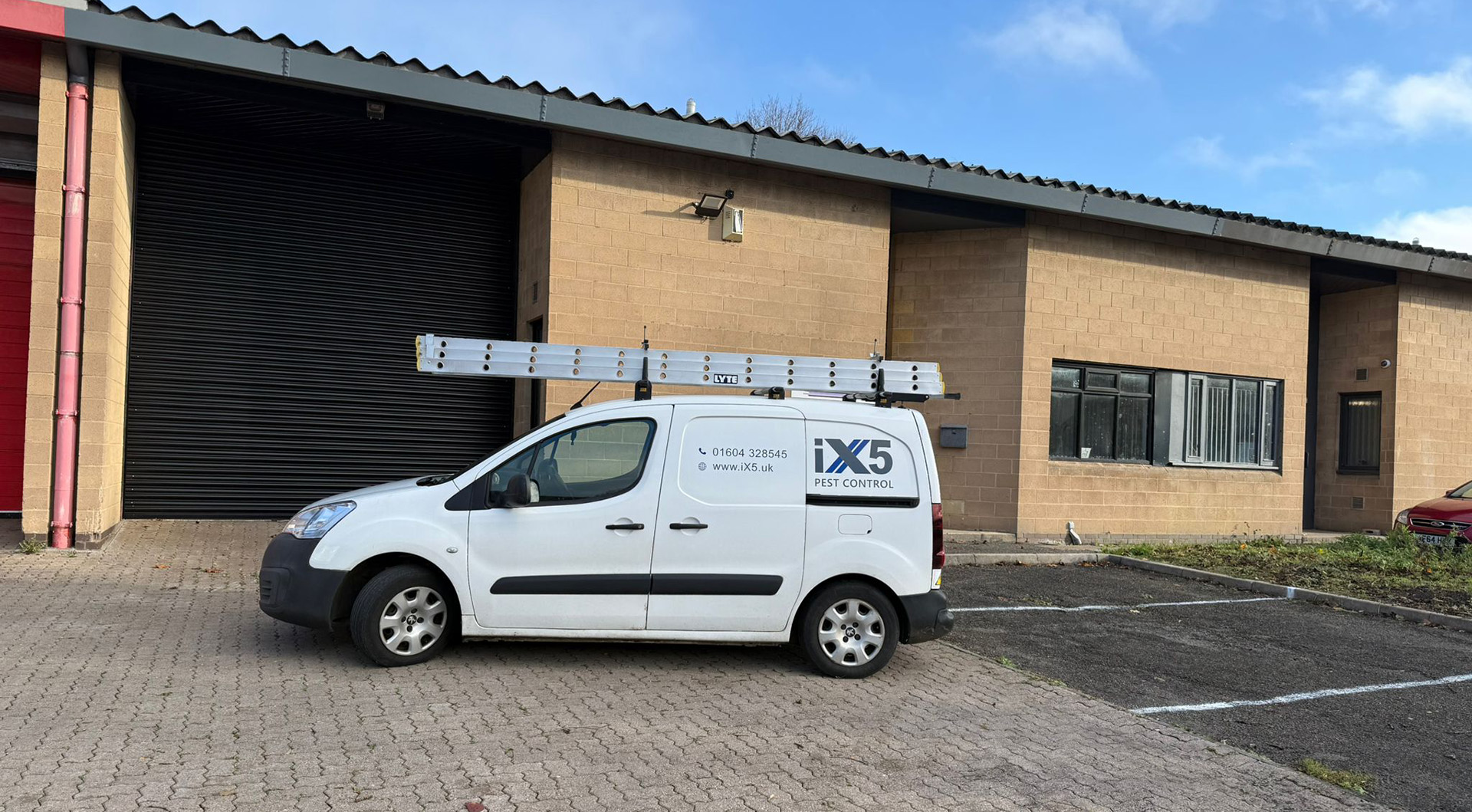 iX5 Pest Control van parked outside commercial warehouse unit in Northamptonshire providing commercial pest control services across Northampton, Milton Keynes, Rugby and surrounding business areas