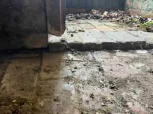 Damaged timber door frame creating a rat access point into a boiler room at a Northamptonshire church